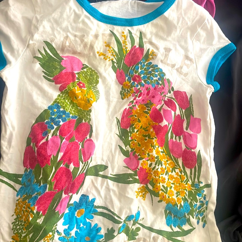 White with floral and bird design toddler Gucci t-shirt.